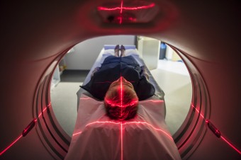 Image of a person undergoing a CAT scan in hospital 