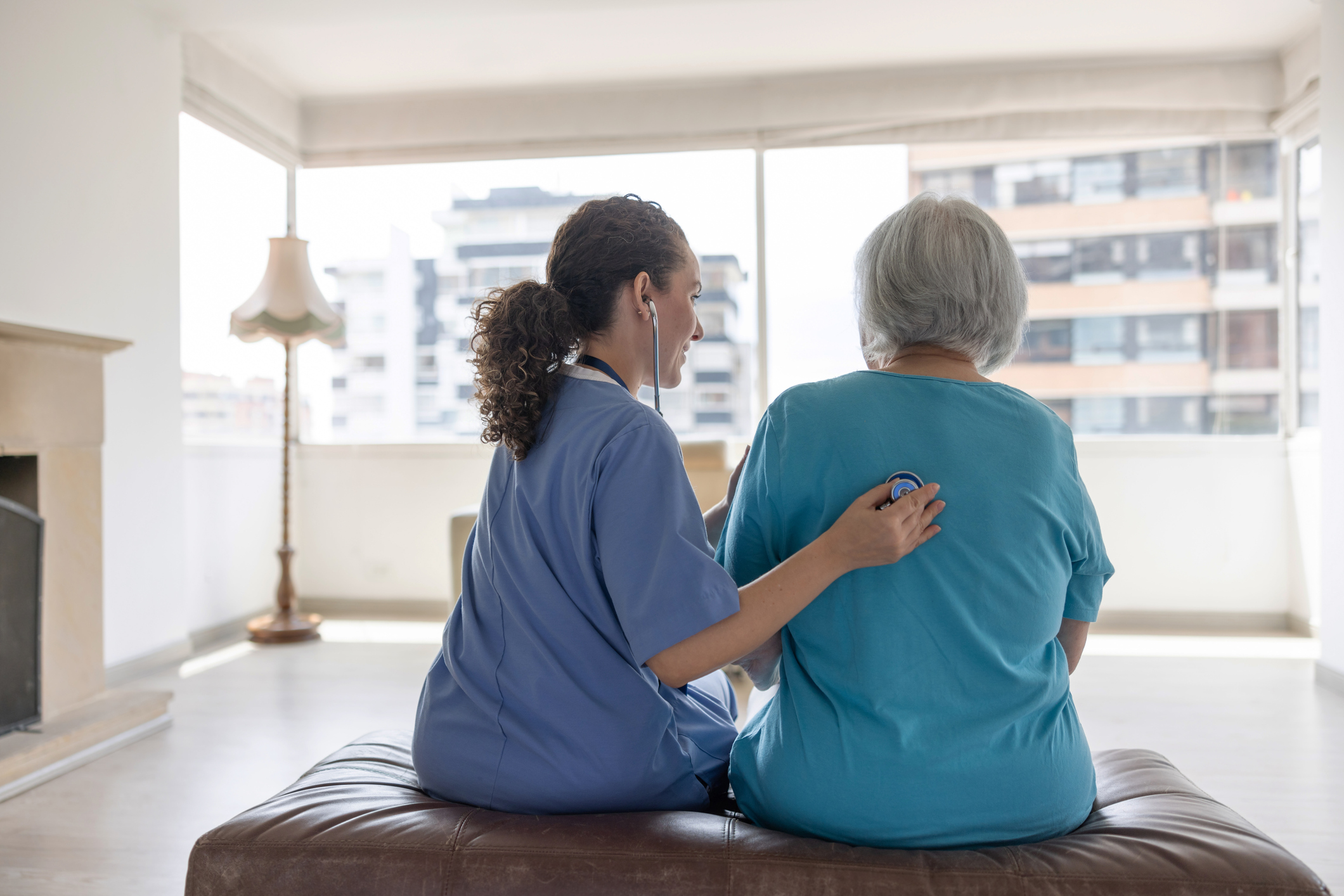 stock image of medic listening to chest of older person with stethoscope