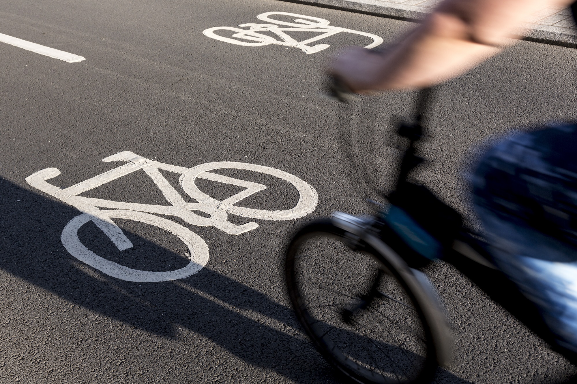 a small commuter bike enters a paved bicycle path