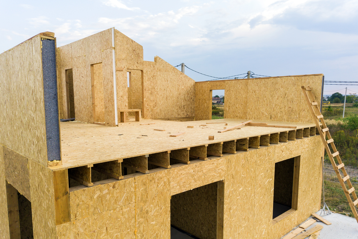 photograph of house underconstruction with prefabricated timber components