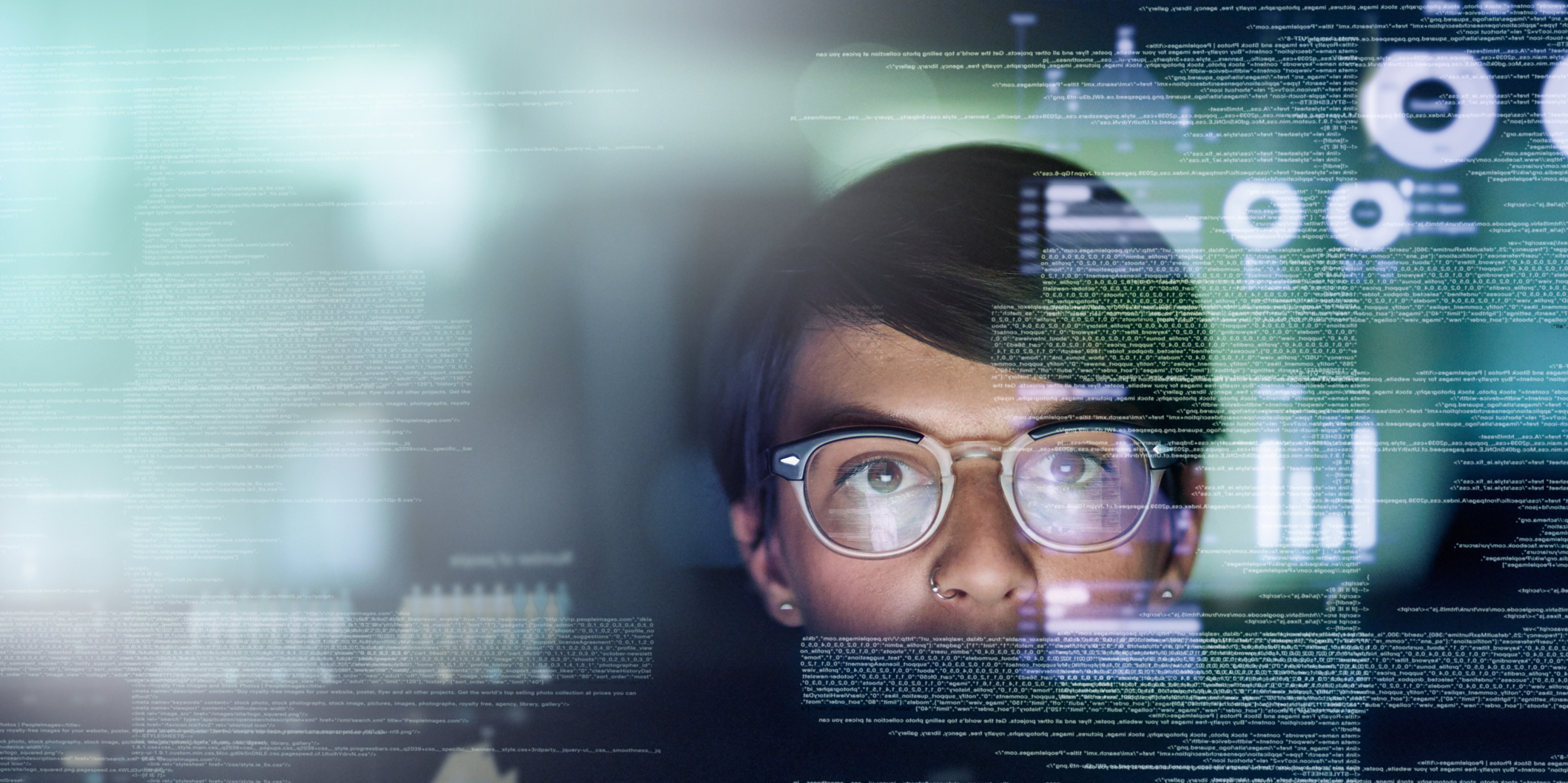 image of person lit by computer screen with superimposed code