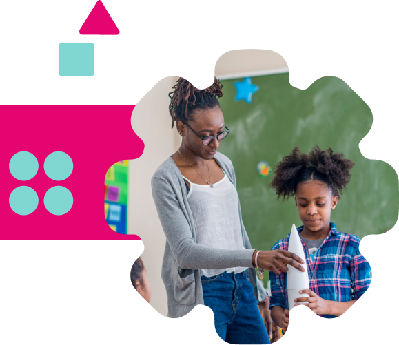 Teacher and student standing at the top of the classroom with a plastic white rocket