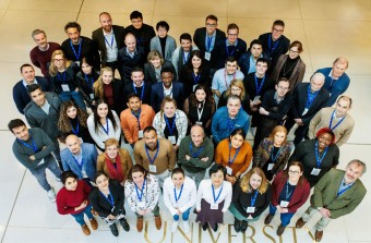 Image of large group of people standing together. Photograph is taken from above. 