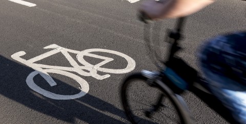 a small commuter bike enters a paved bicycle path