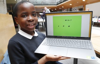 Image of a student holding a laptop
