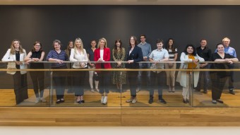 Image of 16 people standing in a building - the full AI PREMie team