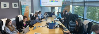 Image of many people in a meeting room 