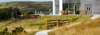 Ballycroy Visitor Centre surrounded by fields and rolling hills 