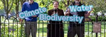 This image shows three people (a woman and two men) holding signs that each say 'Climate, Biodiversity, Water'.
