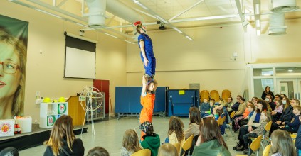 Children watching a science show in a hall.