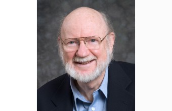 close up of Prof William C Campbell wearing a suit smiling