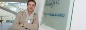 Image of a male leaning up against a Insight Logo from an SFI research centre.