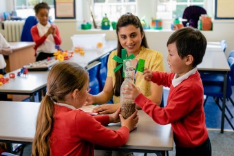 Two students and a teacher playing with a homemade wind turbine