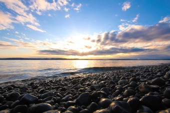 Picture of a stony beach at a sunset