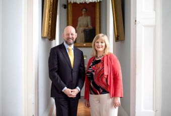 Prof Ita Richardson, Deputy Director, Lero SFI Research Centre for Software at UL, is pictured with Prof Philip Nolan, Director General of SFI standing side by side with framed art behind them.