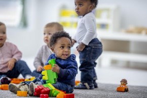 Image of toddlers playing with colourful blocks