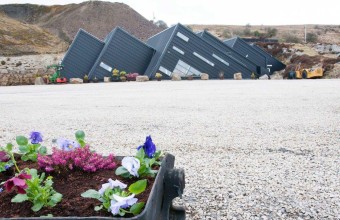 Entrance to the Arigna Mining Experience in the background with flowers in the foreground