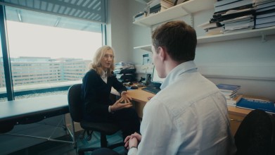 Image of a clinician and patient speaking in an office 