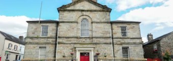 Lismore Heritage centre building surronded by a gate and flowers