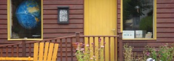 A person tending to the plants at the font of An Gáirdín, Organic & Ecology Centres buiding