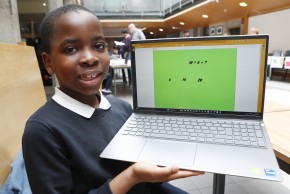 Image of student holding a laptop