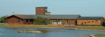 Wexford Wildfowl Reserve building surrounded  by a lake
