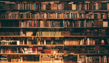 An image of a library shelf filled with books