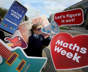 Young girl students promoting maths week 