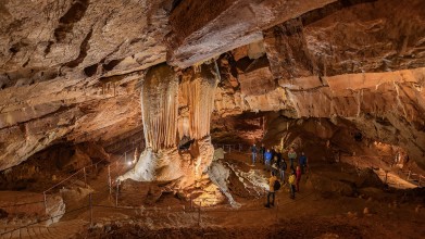 image of orange colour caves with people inside