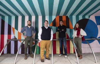 An image of Dr Thomaz Bastiaanssen, Prof John Cryan, Dr Marcus Boehme and Katherine Guzzetta standing in front of a brightly coloured wall outdoors
